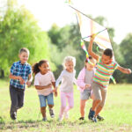 Group of happy children with kite in park